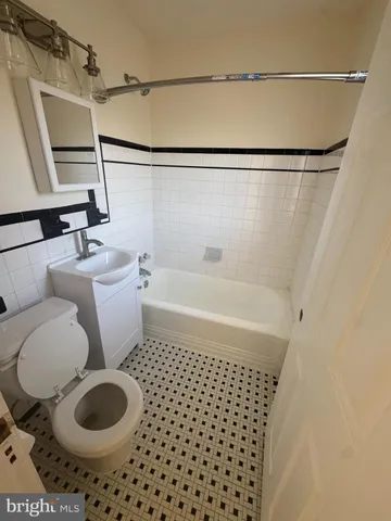 a bathroom with a toilet and a bathtub