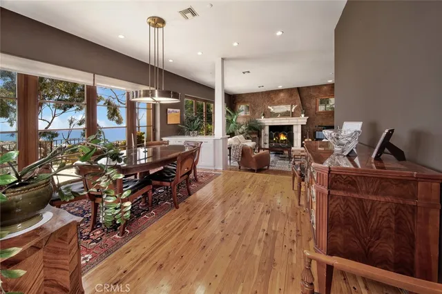 a living room with furniture large window and wooden floor