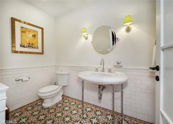 a bathroom with a toilet a sink and mirror