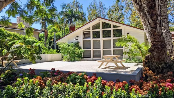 a view of small yard in front of house with trees