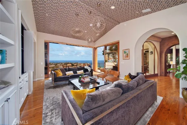 a living room with furniture a rug and a large window