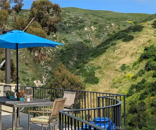 a view of balcony with furniture and umbrella