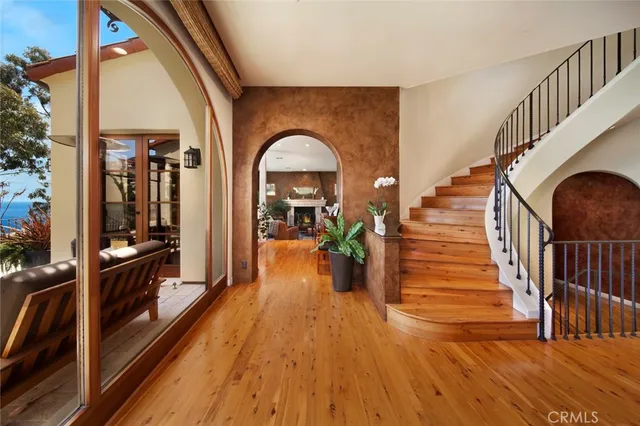 a view of entryway and hall with wooden floor