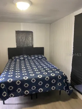 a bedroom with a bed and a tv