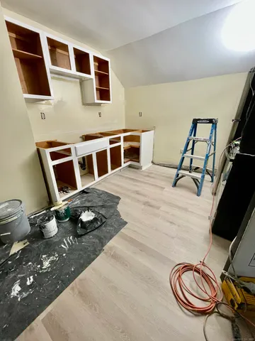 a bedroom with a bed and a flat tv screen on the dresser