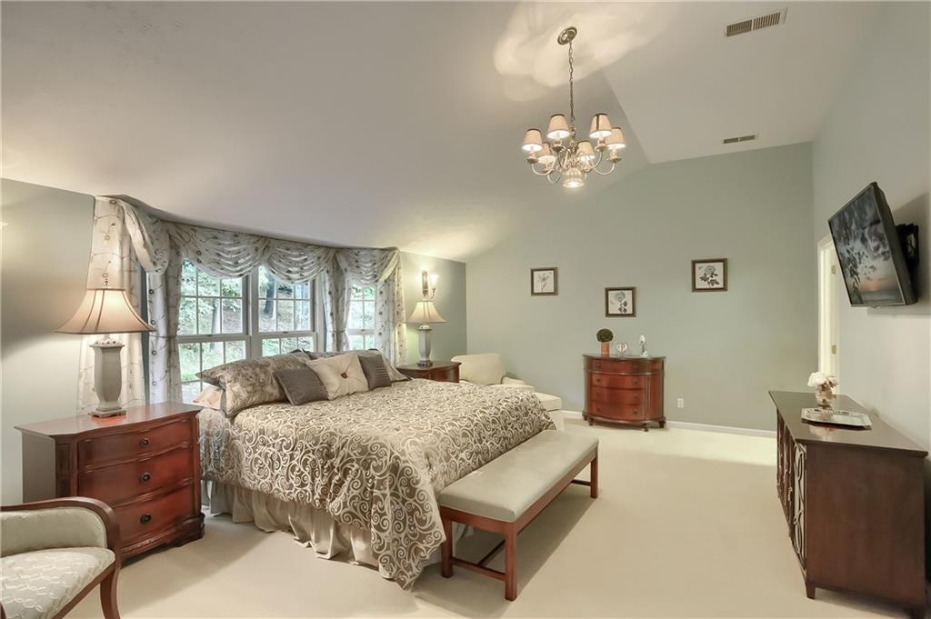 119 Berwyn Road Pittsburgh, PA 15237 - Photo 15 of 25 a bedroom with a large bed and a chandelier