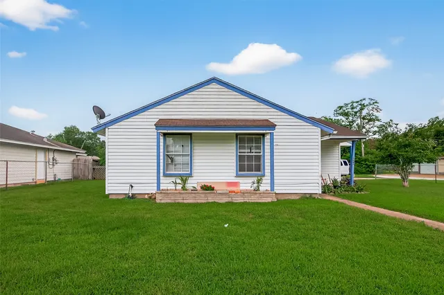 a front view of house with yard and green space