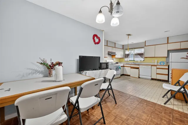 a view of a dining room with furniture and a kitchen