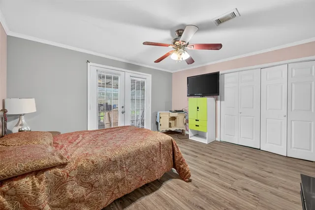 a bedroom with a bed a table and a chandelier