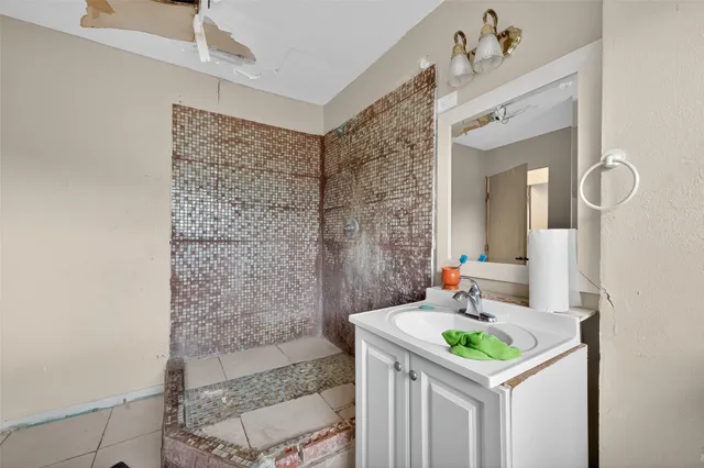 a bathroom with a sink a toilet and mirror