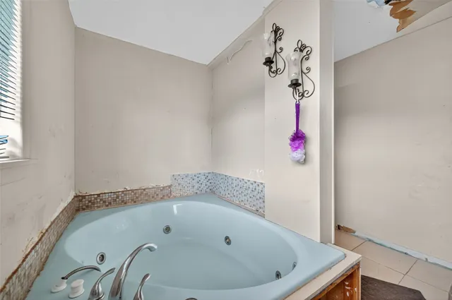 a bathroom with a bathtub and shower
