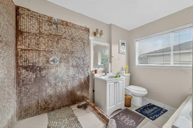 a bathroom with a sink toilet and shower