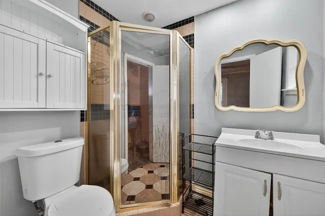 a bathroom with a toilet sink and shower