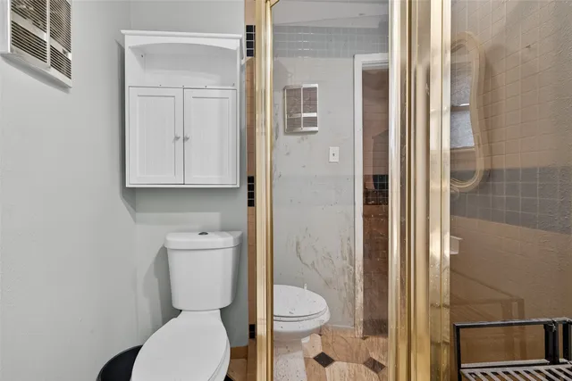 a white toilet sitting next to a bathroom sink