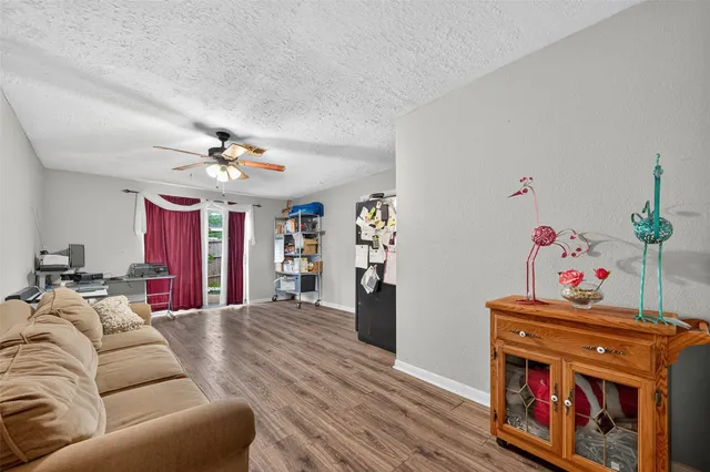a living room with furniture and wooden floor