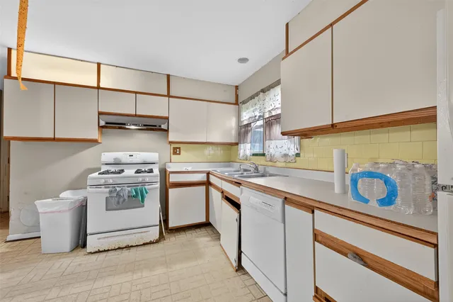 a kitchen with a stove and a sink