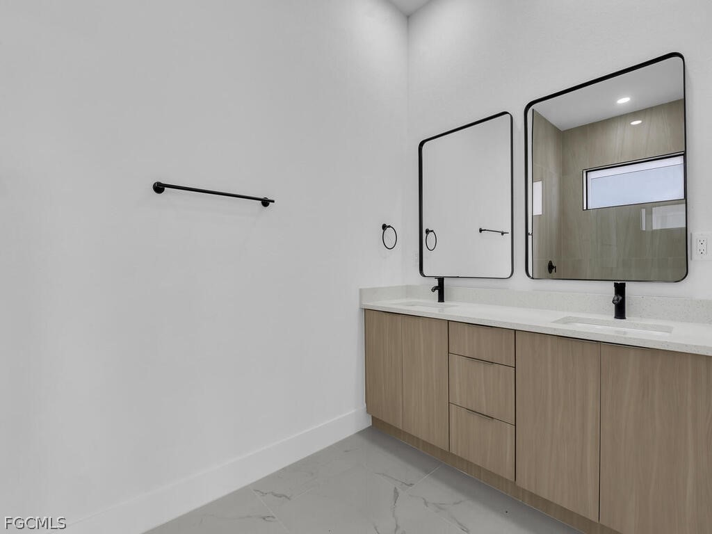 1839 Lockhaven Court Lehigh Acres, FL 33972 - Photo 12 of 23 a bathroom with a sink and a mirror