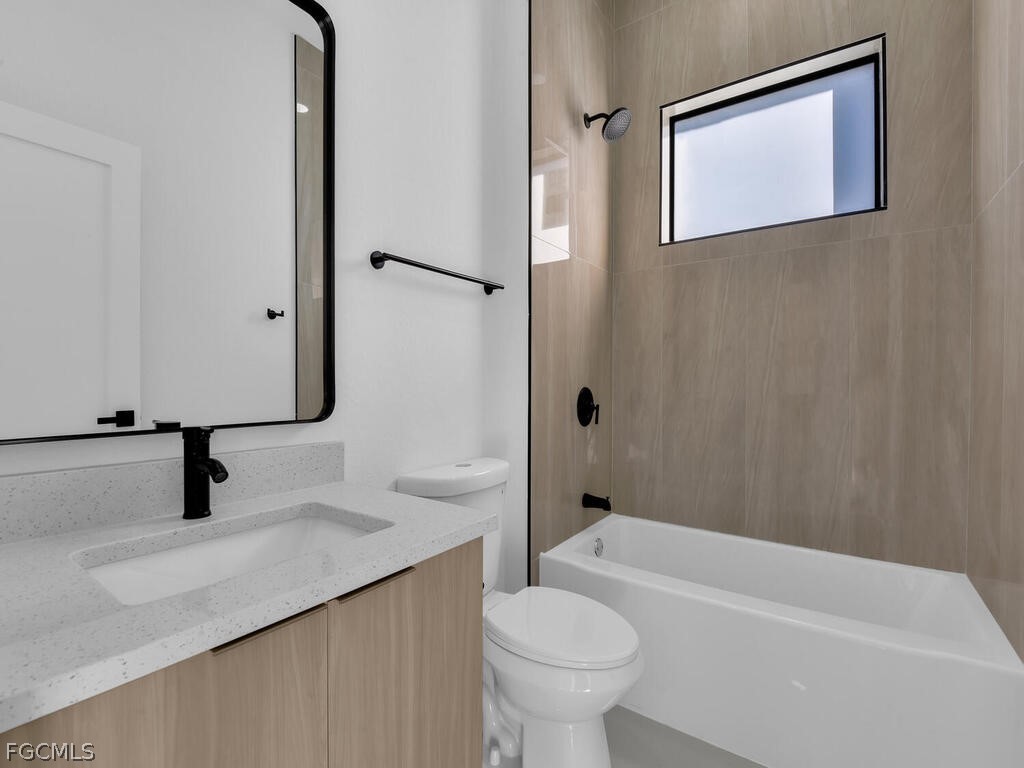 1839 Lockhaven Court Lehigh Acres, FL 33972 - Photo 17 of 23 a bathroom with a sink a toilet and a bathtub