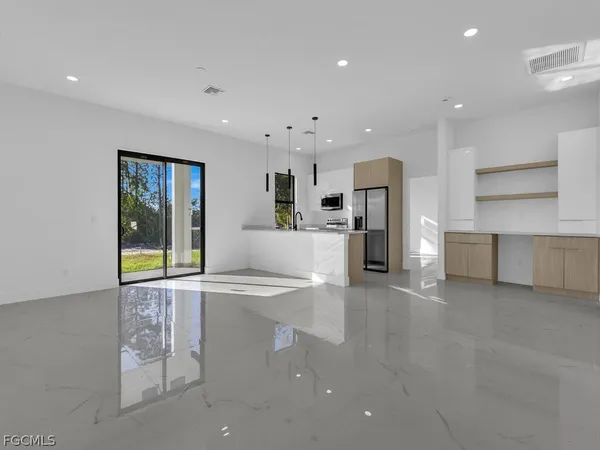 a large kitchen with a large window and stainless steel appliances