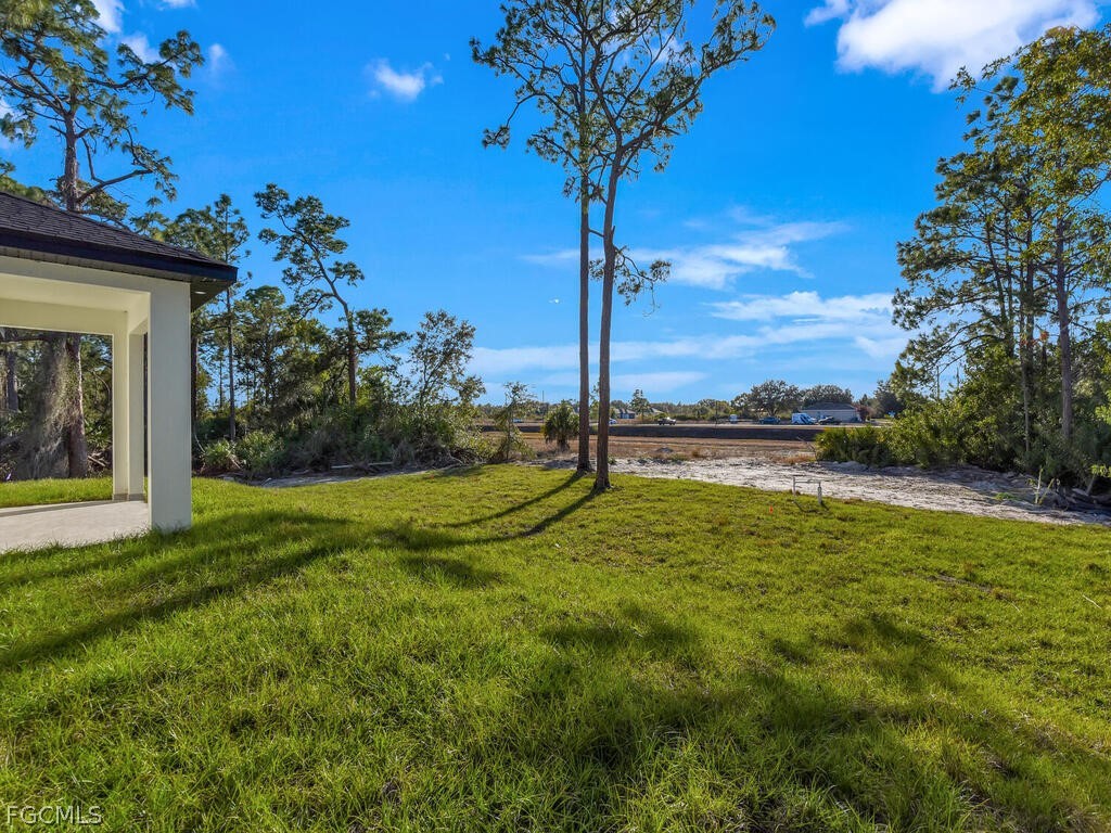 1839 Lockhaven Court Lehigh Acres, FL 33972 - Photo 21 of 23 a view of a garden with a tree