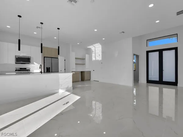 a large white kitchen with lots of counter space