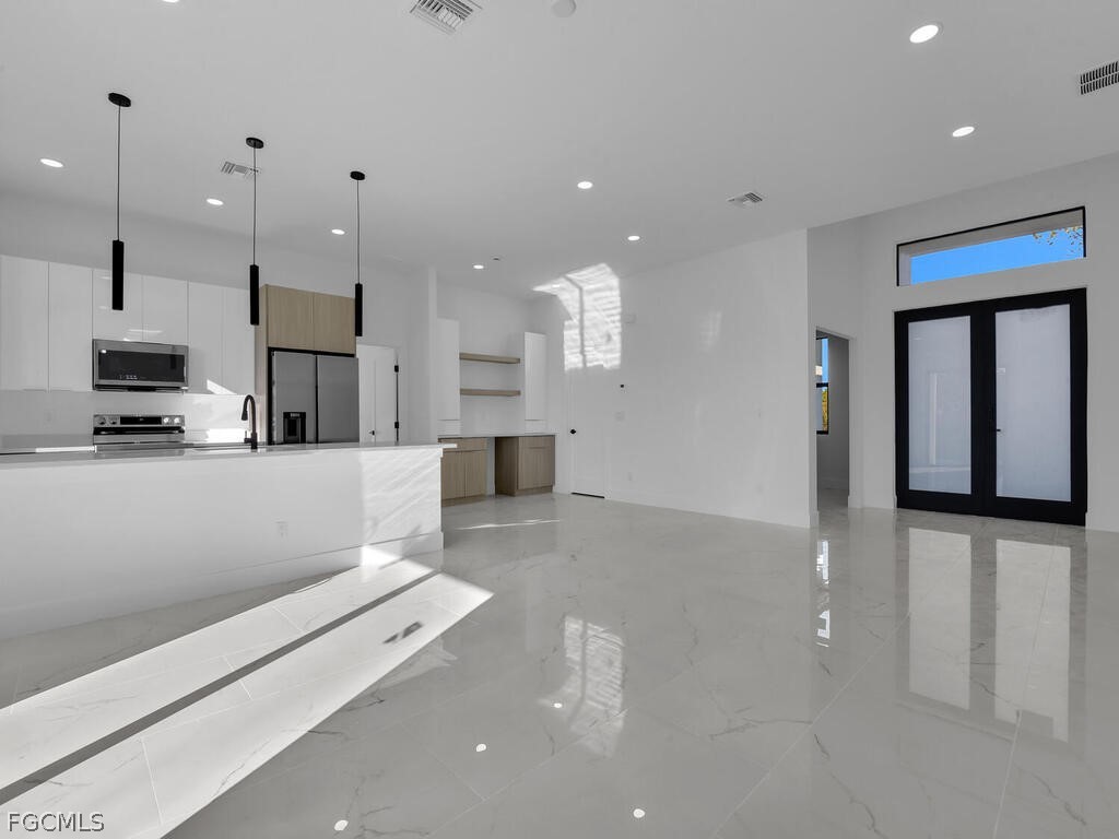 1839 Lockhaven Court Lehigh Acres, FL 33972 - Photo 3 of 23 a large white kitchen with lots of counter space