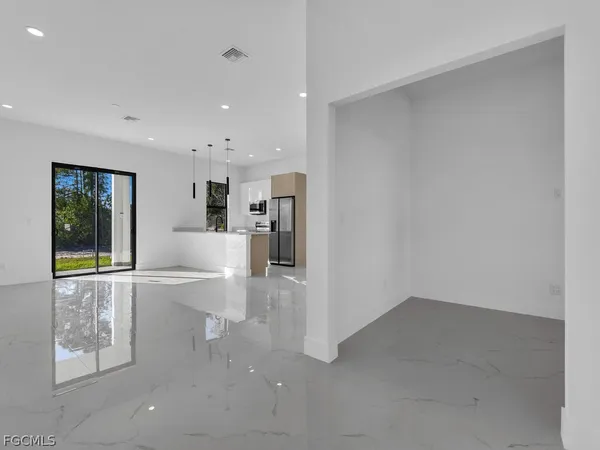 a living room with a sink furniture and a large window