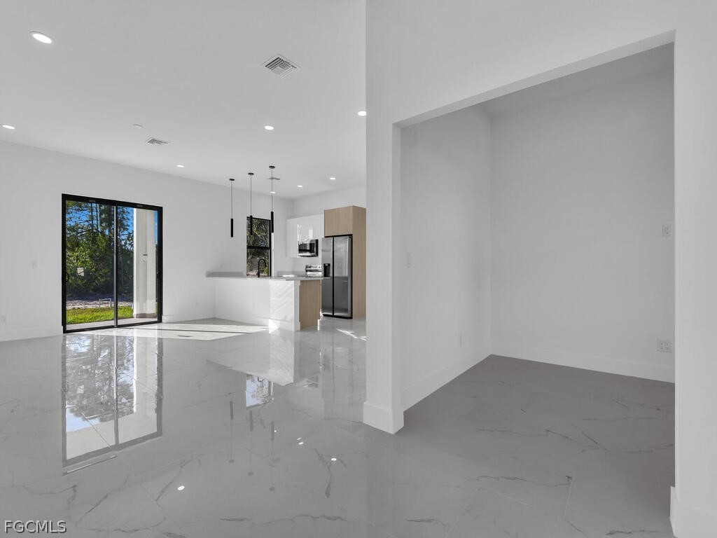 1839 Lockhaven Court Lehigh Acres, FL 33972 - Photo 4 of 23 a living room with a sink furniture and a large window