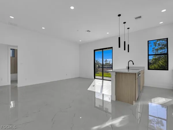 a kitchen with stainless steel appliances a refrigerator and a sink