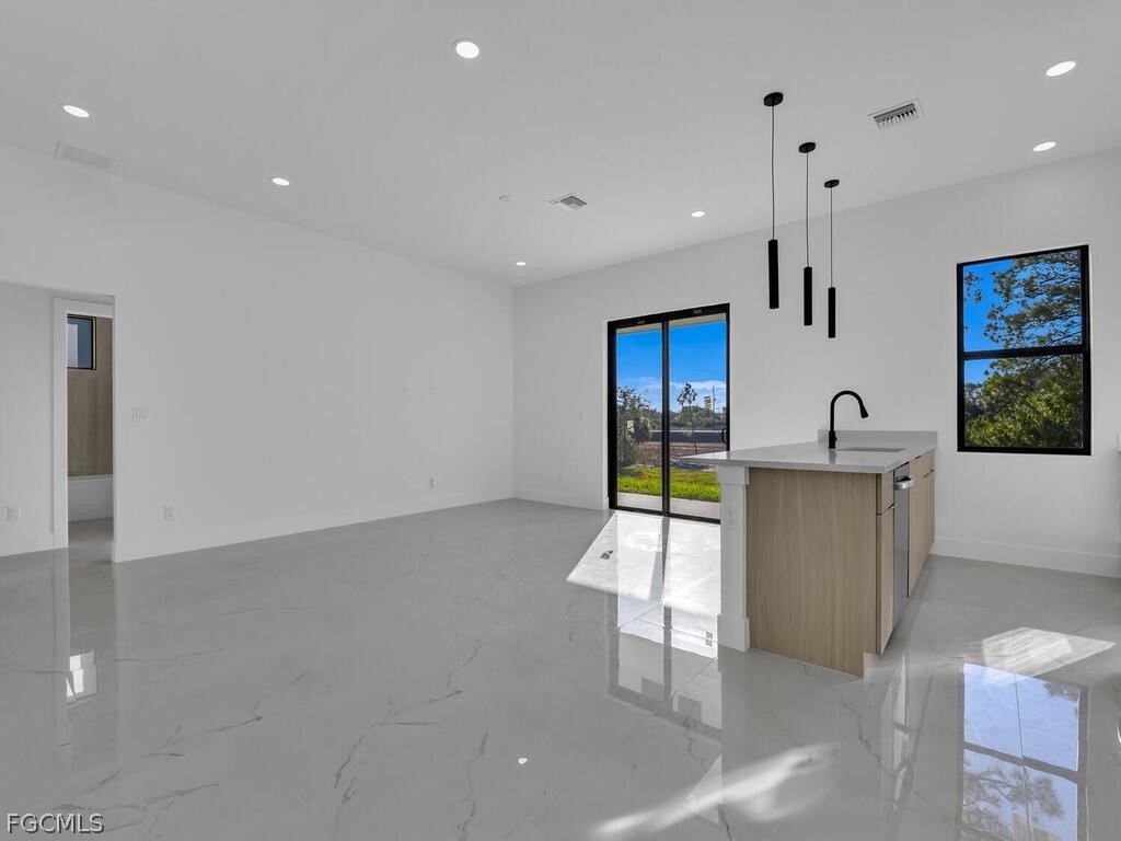 1839 Lockhaven Court Lehigh Acres, FL 33972 - Photo 8 of 23 a kitchen with stainless steel appliances a refrigerator and a sink