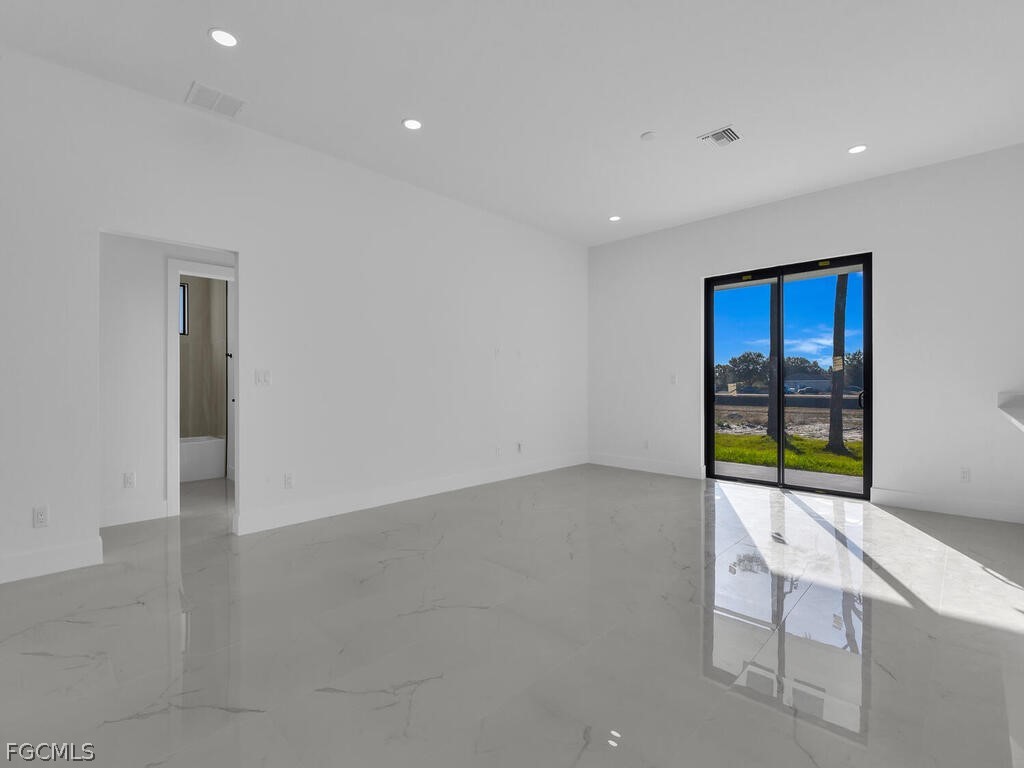 1839 Lockhaven Court Lehigh Acres, FL 33972 - Photo 9 of 23 an empty room with windows