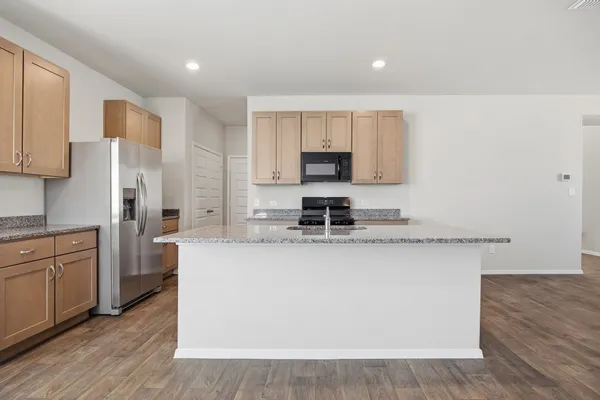 a kitchen with stainless steel appliances granite countertop a stove and a sink