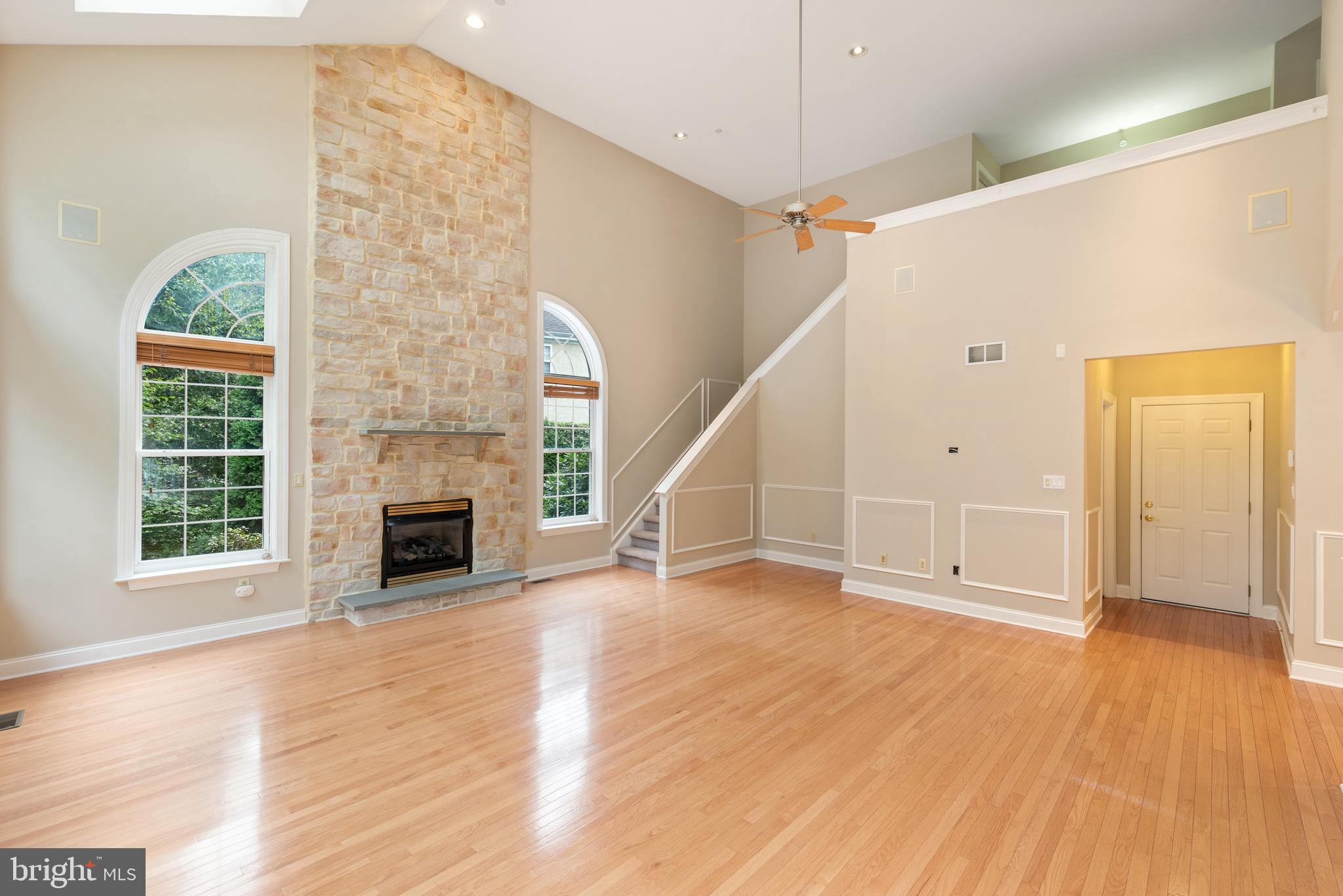 746 Kelli Lane Springfield, PA 19064 - Photo 9 of 35 Stone-to-ceiling fireplace and back stairway