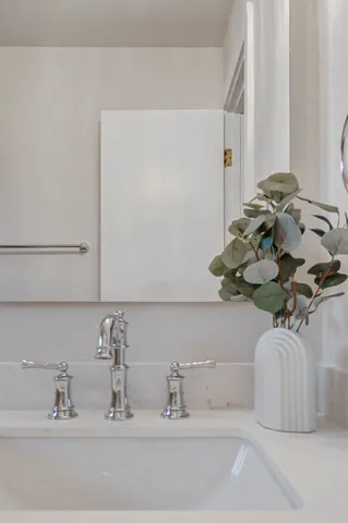 a bathroom with a sink and a mirror