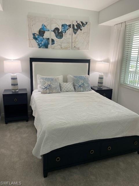 15275 Grn Acrs Avenue, Unit 337 Punta Gorda, FL 33982 - Photo 14 of 17 a bedroom with a bed and a night stand