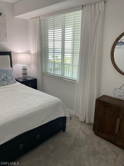 15275 Grn Acrs Avenue, Unit 337 Punta Gorda, FL 33982 - Photo 16 of 17 a spacious bedroom with a bed and a mirror