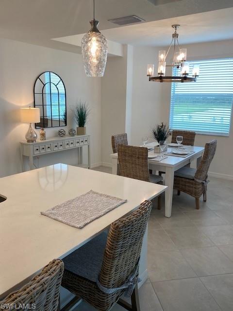 15275 Grn Acrs Avenue, Unit 337 Punta Gorda, FL 33982 - Photo 7 of 17 a dining room with a table chairs and kitchen view