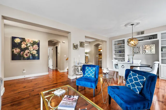 a living room with furniture dining area and a window