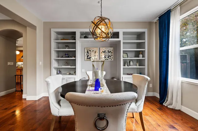 a living room with furniture a rug and wooden floor