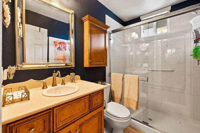 a bathroom with a sink toilet and shower