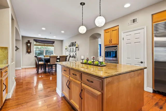 a kitchen with wooden cabinets and center island