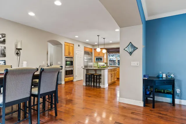 a view of a dining room with furniture and wooden floor