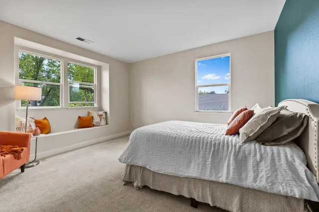 a bedroom with a bed and a couch