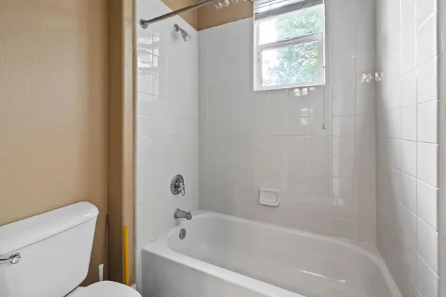 a white bath tub sitting next to a white toilet