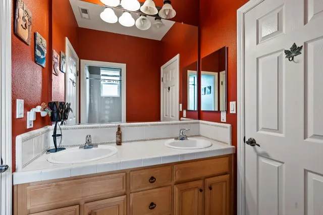 a bathroom with a sink double vanity and a mirror