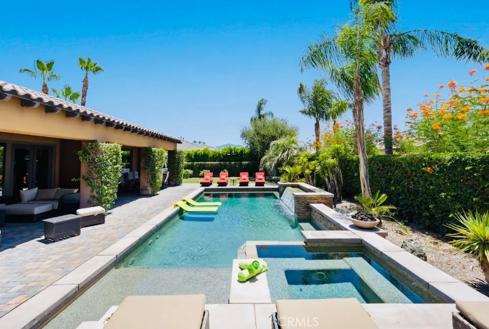a view of a house with swimming pool and sitting area