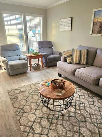 a dining room with furniture window and wooden floor