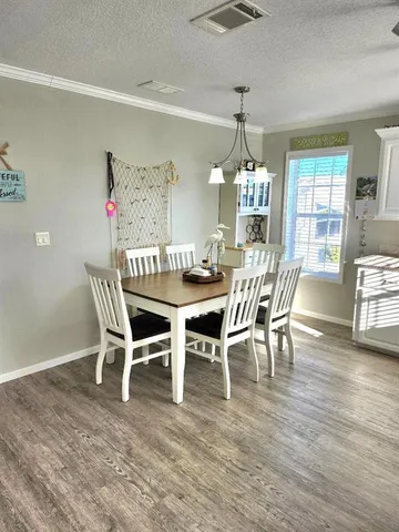 a kitchen with cabinets a counter and stainless steel appliances