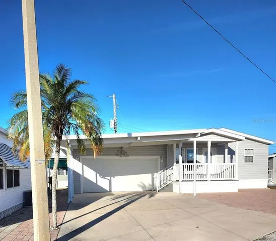 a front view of a house with glass top table and chairs