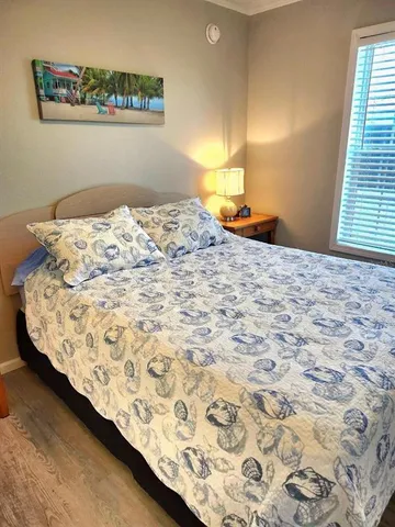 a bed sitting in a bedroom next to a window